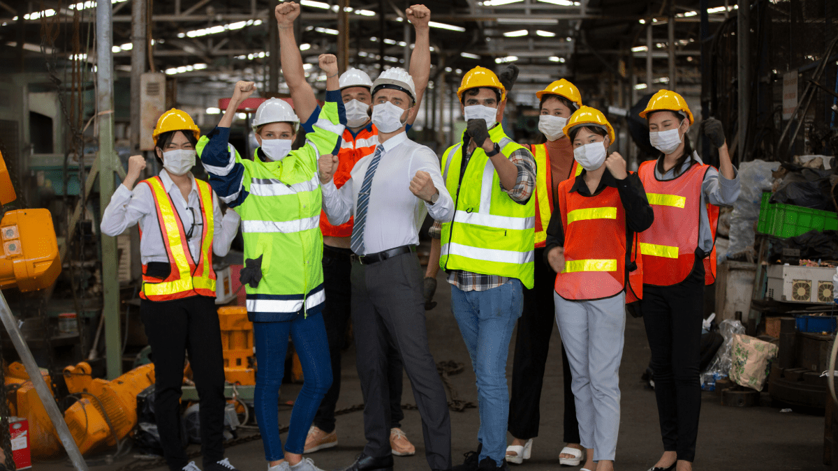 Factory workers who are happy due to improved employee motivation